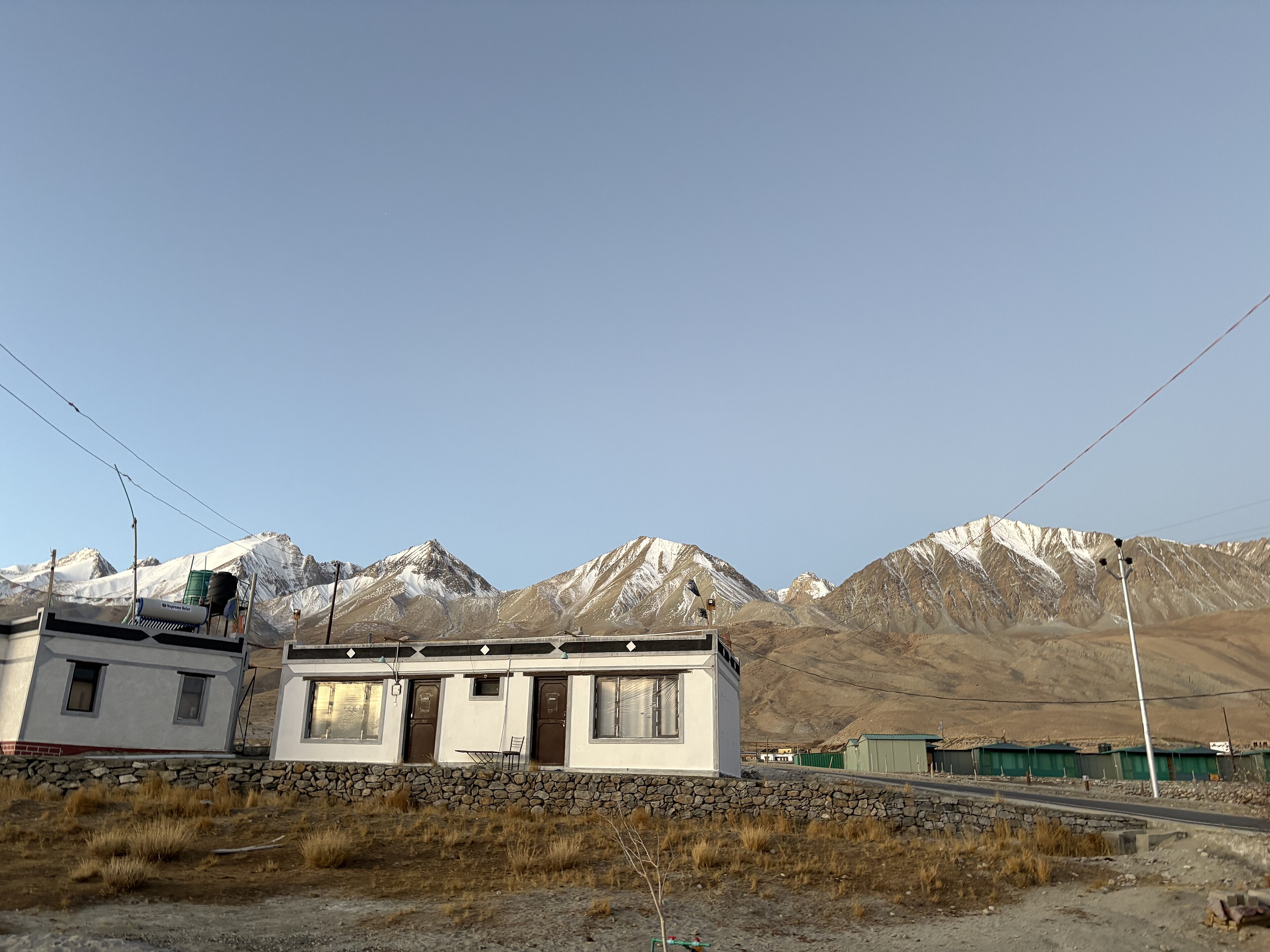 Snow-capped peaks and a frozen lake on a Ladakh high-pass road trip